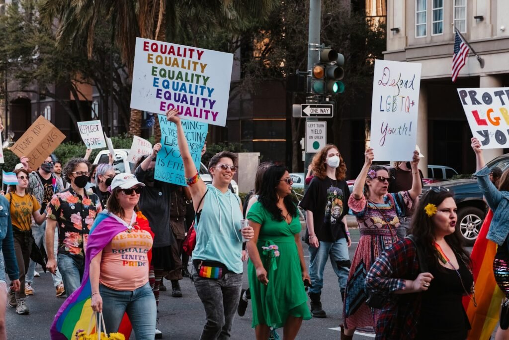 Embracing Your Truth: The Life-Changing Power of Transgender Therapy in Chicago 1 a group of people walking down a street holding signs: Transgender Therapy