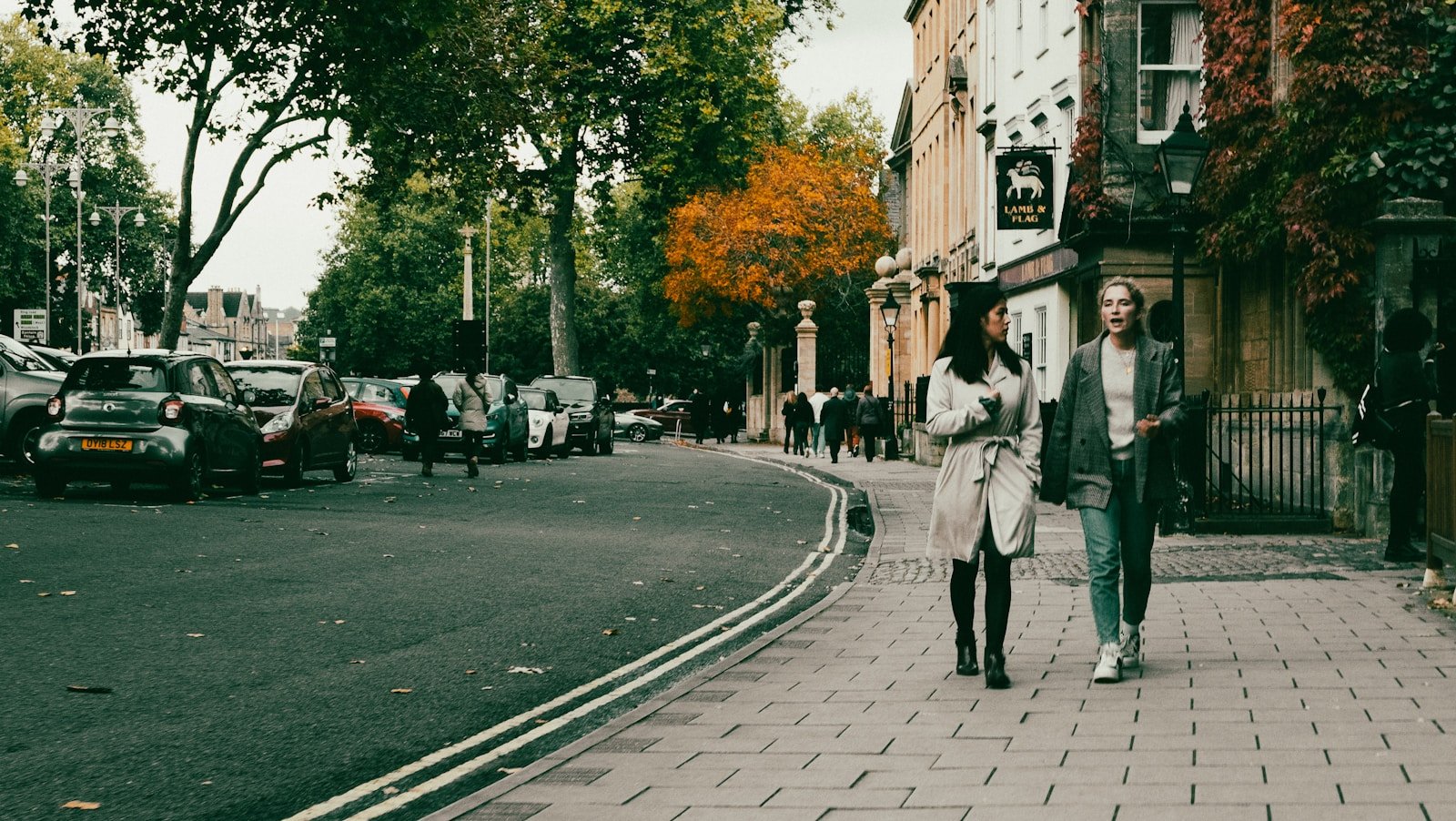 a couple of people walking down a street: Walk and Talk Therapy
