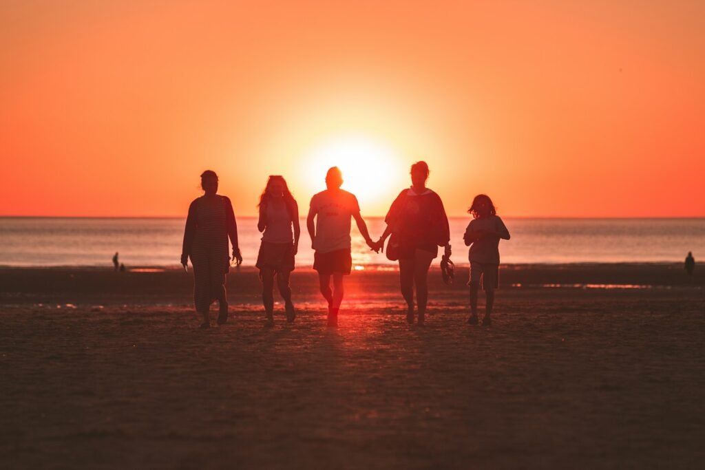 Strengthen Your Bonds: 7 Transformative Benefits of Family Counseling in Chicago 9 silhouette photo of five person walking on seashore during golden hour: family counseling