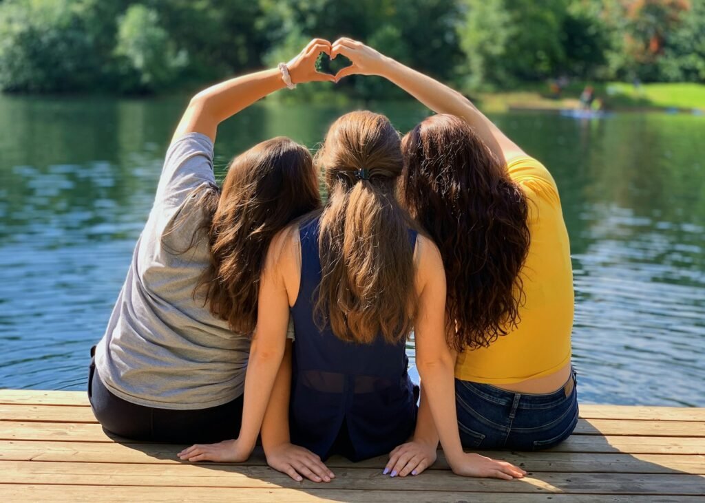 Thrive with Confidence: 7 Transformative Benefits of Teen Therapy in Chicago 5 2 women sitting on wooden dock during daytime: teen therapy