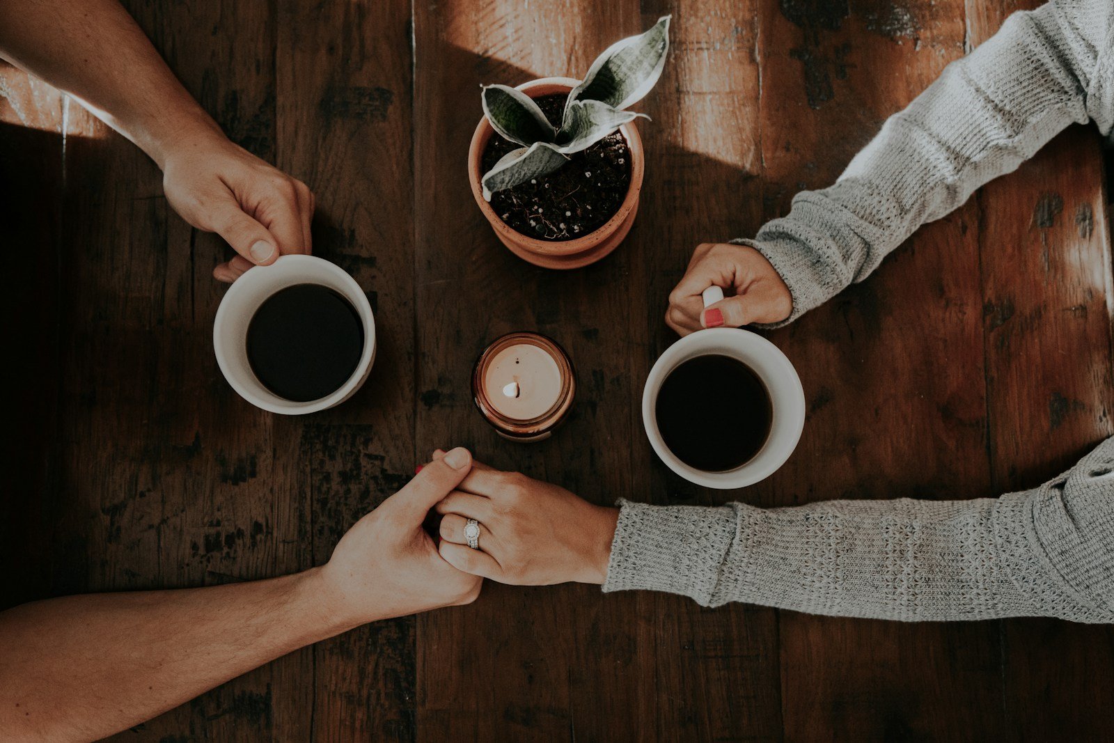 person holding white ceramic mugs: couples counseling