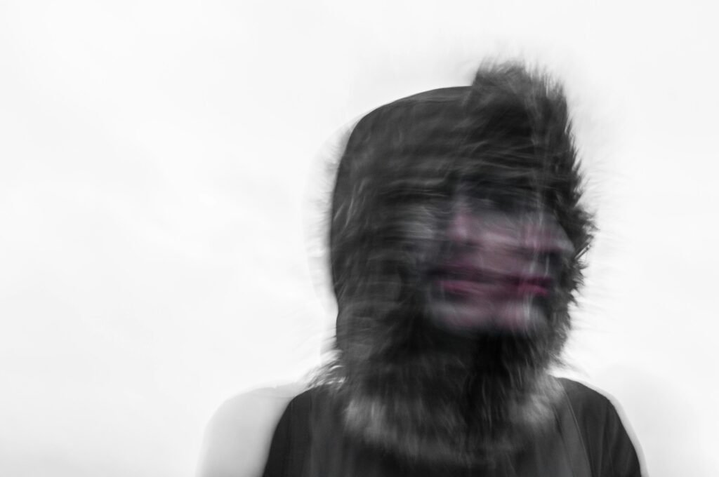 Overcome Your Fears: 7 Transformative Benefits of Anxiety Therapy in Chicago 3 Creepy blurred photo of a person's face and a furry hood: Anxiety Therapy