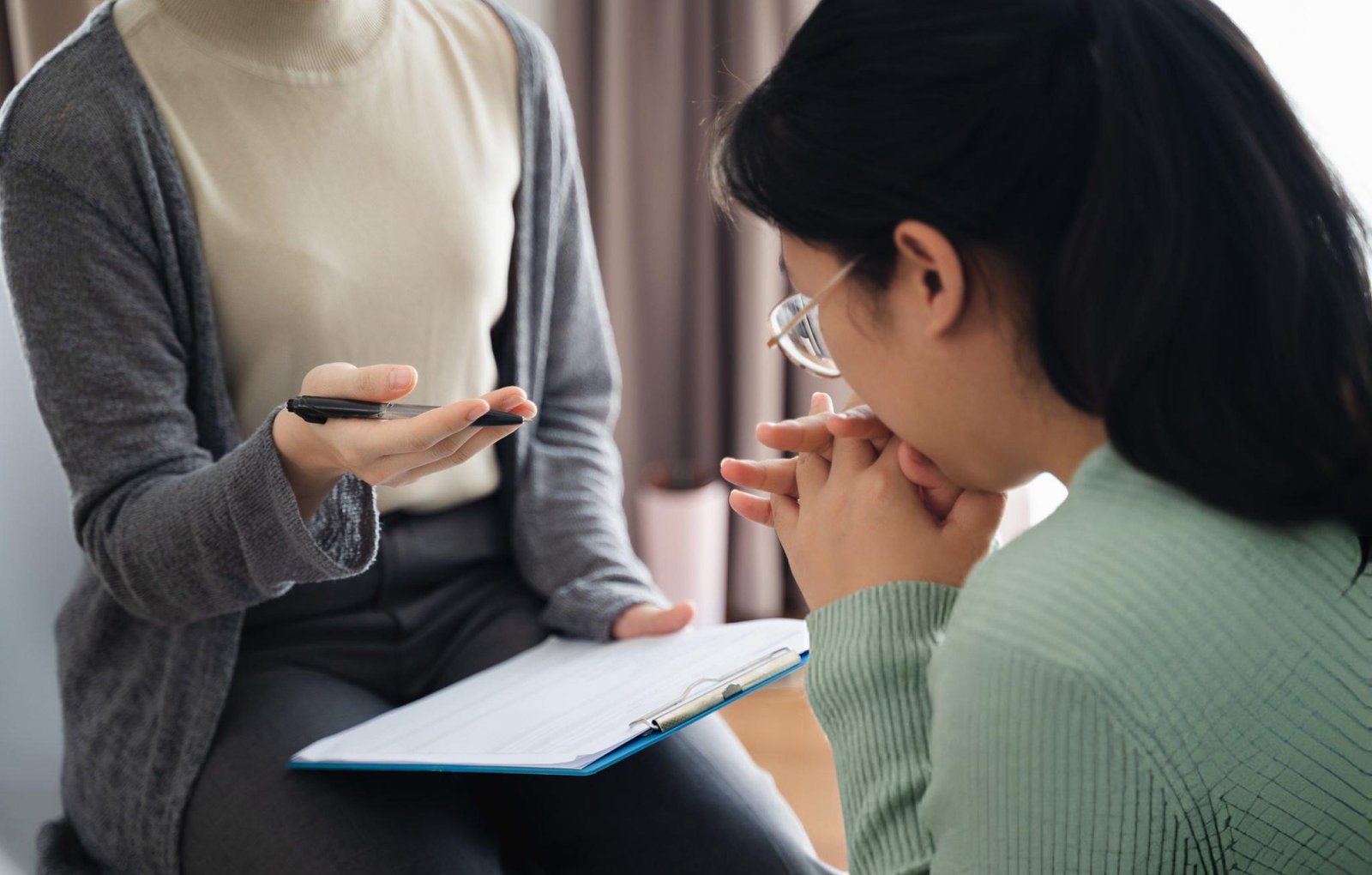 Woman journaling in therapy session – Pain Unearthed healing journey