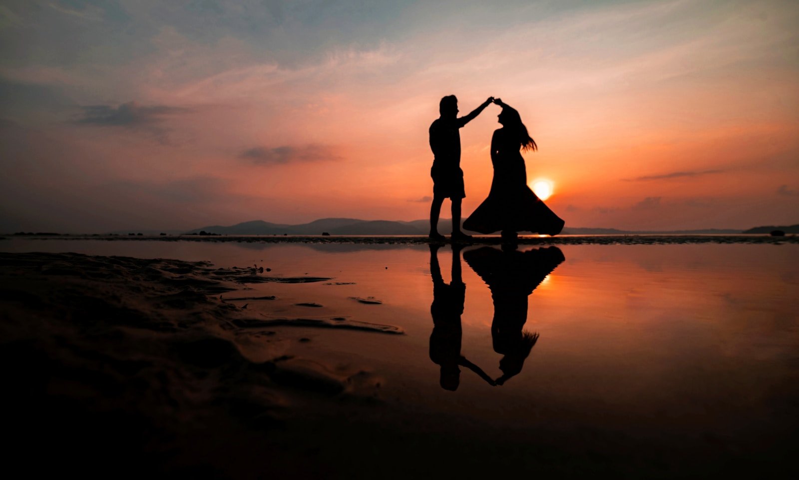 silhouette of man and woman kissing on beach during sunset: Couples Therapy