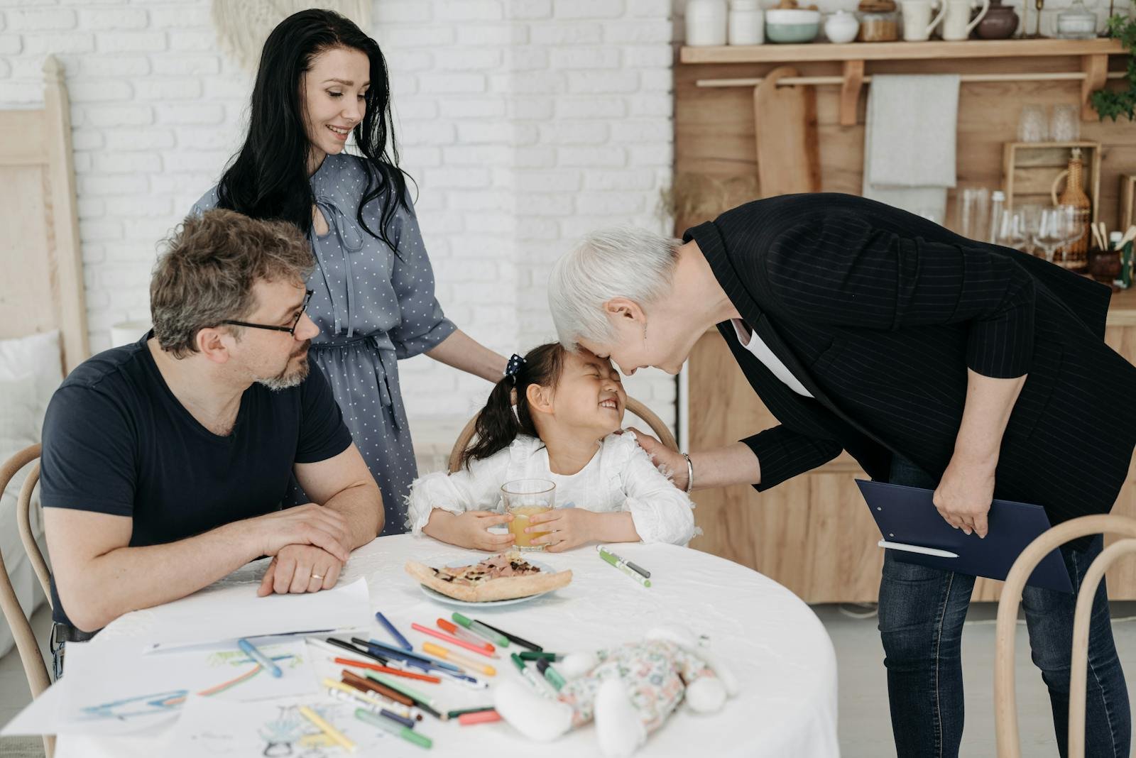 A happy family with a social worker in a warm indoor setting, discussing child welfare.